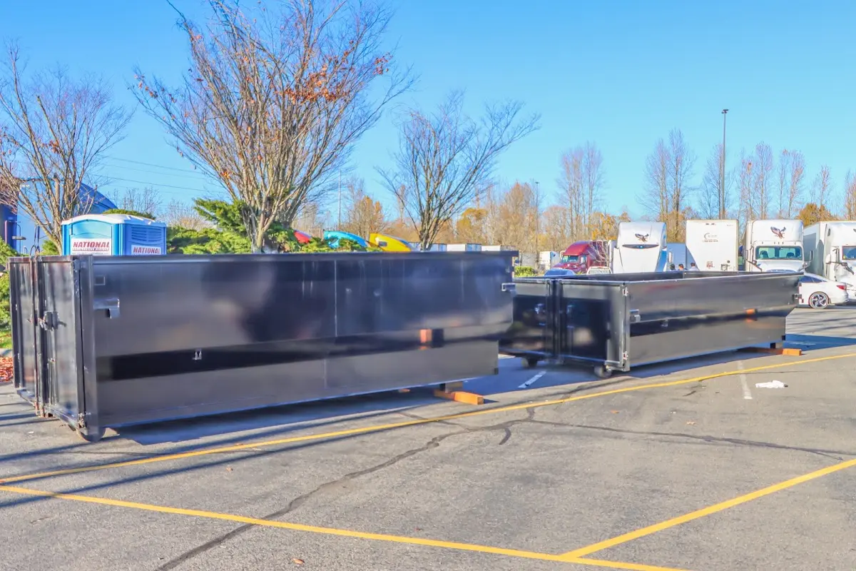 Professional dumpster rental service with roll-off container on residential driveway in Colonial Heights